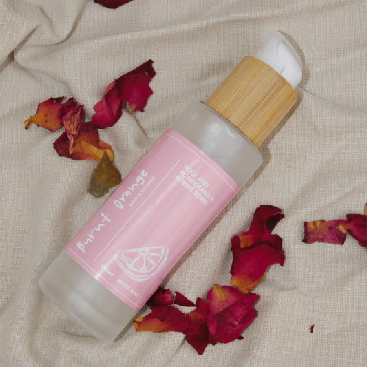 Revive Rose and Pomegranate Tonic on natural linen background